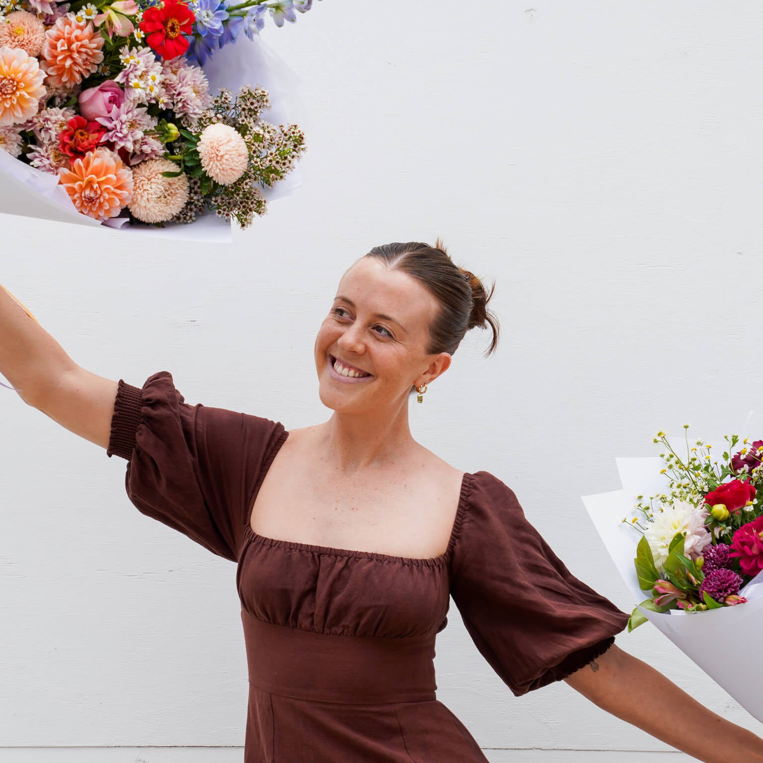 A lady dancing with flowers at Poppy Rose Flower Delivery in Brisbane