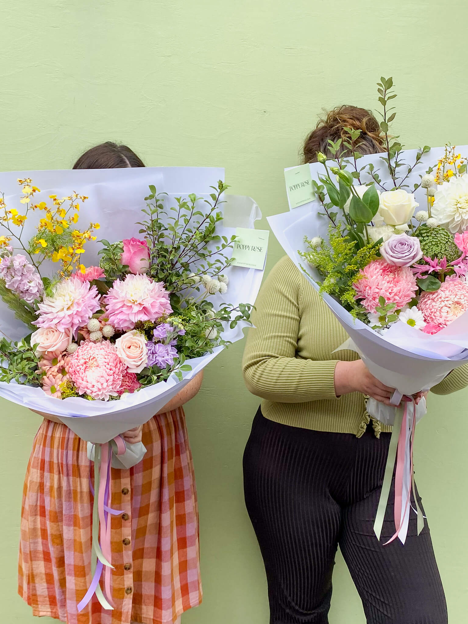 Two ladies holding big bunches of flowers from Poppy Rose in Brisbane