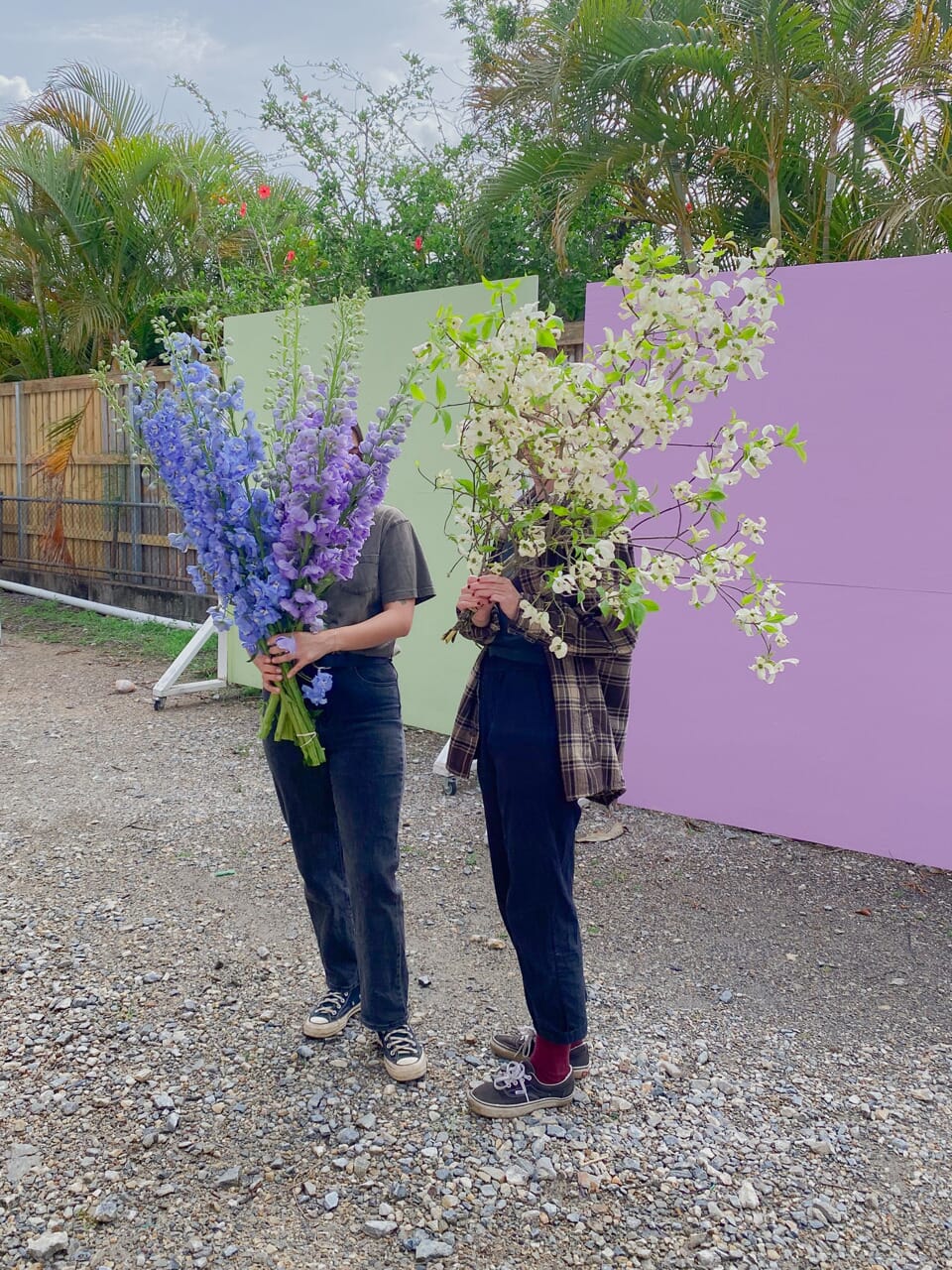 Girls holding big bunches of flowers for delivery in Brisbane by Poppy Rose Flowers