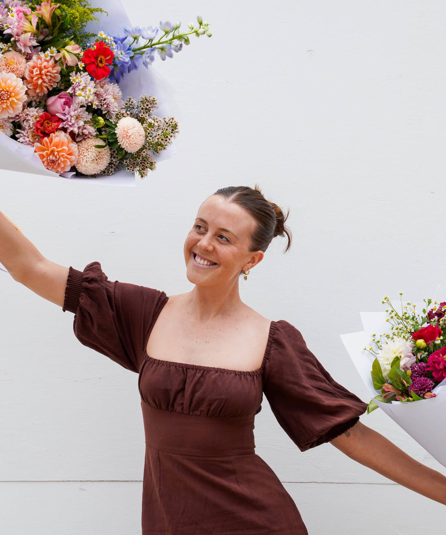 A lady dancing with flowers at Poppy Rose Flower Delivery in Brisbane