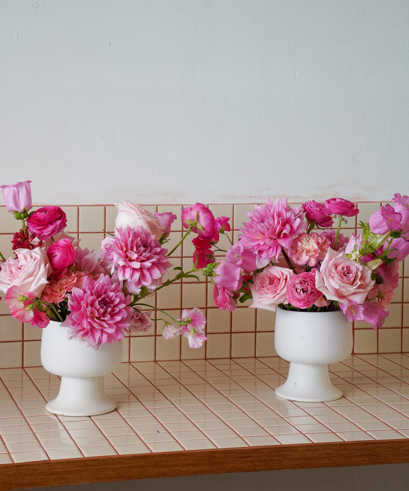 Bright Pink Flowers in a white compote vase by Poppy Rose in Brisbane