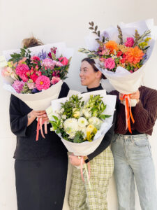 A group of women holding colourful bouquets of flowers in Brisbane