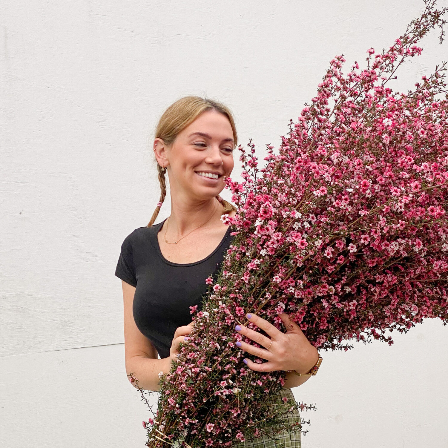 A girl holding a big bunch of pink flowers, available for delivery in Brisbane